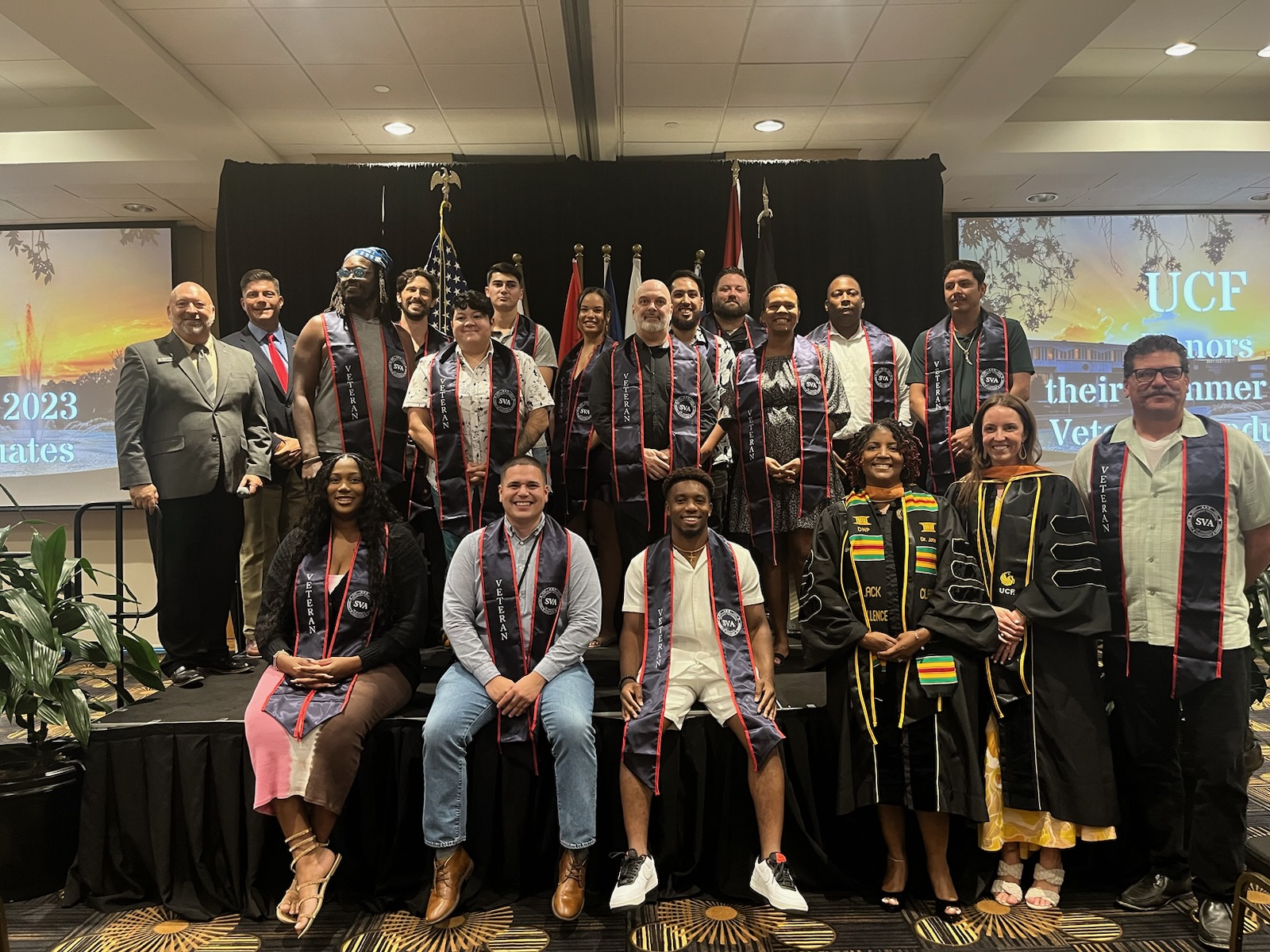 Veteran and Military connected students posing with MVSS staff during the stole ceremony