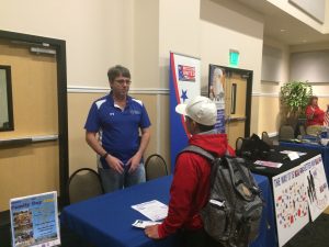 A staff member talking to a student during open house