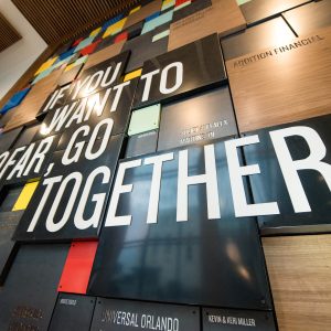 Wall decorated with colorful panels and a quote that reads 'If you want to go far, go together.