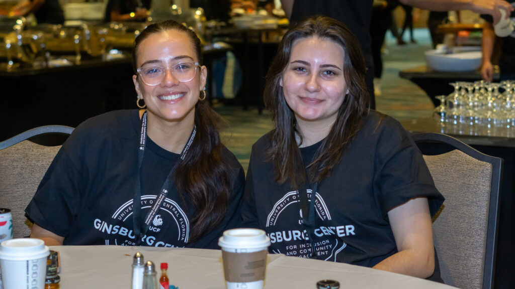 two students wearing matching black shirts posing for a photo