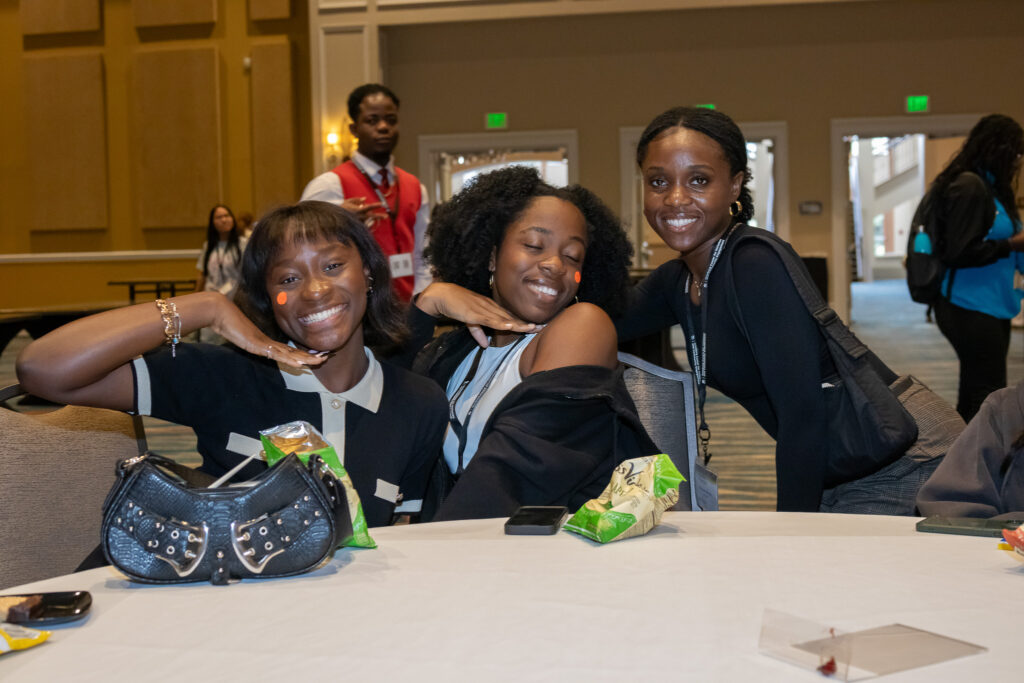 Students posing for a photo at a table