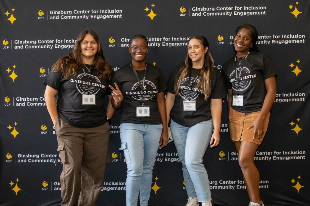 Students posing in front of a backdrop