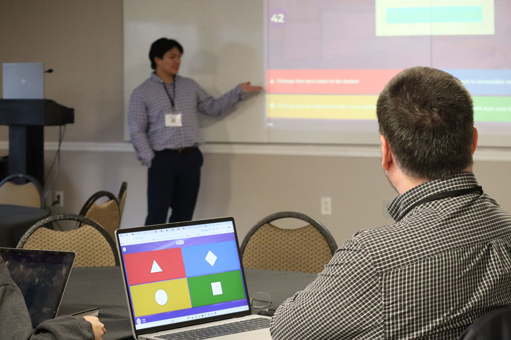 a staff member presenting and another listening